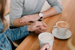 Couple holding hands during a serious relationship conversation