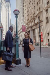 Man and woman having a conversation on a busy city sidewalk
