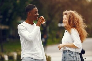 Man approaching a woman in a public setting, illustrating respectful real-world conversation and dating confidence