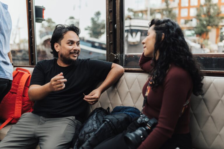 Man confidently approaching a woman in a city setting, illustrating real-life street approach advice