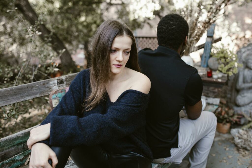 Sad Woman sitting beside Man