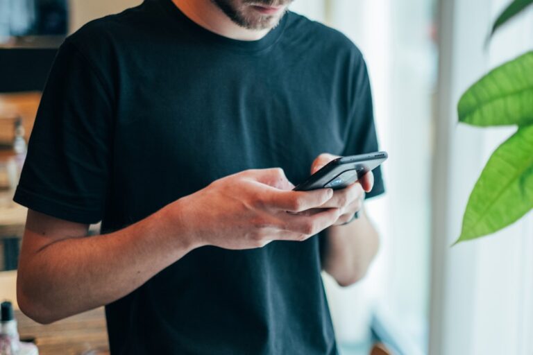 Man texting on a smartphone, illustrating dating app openers, text game and modern messaging strategy