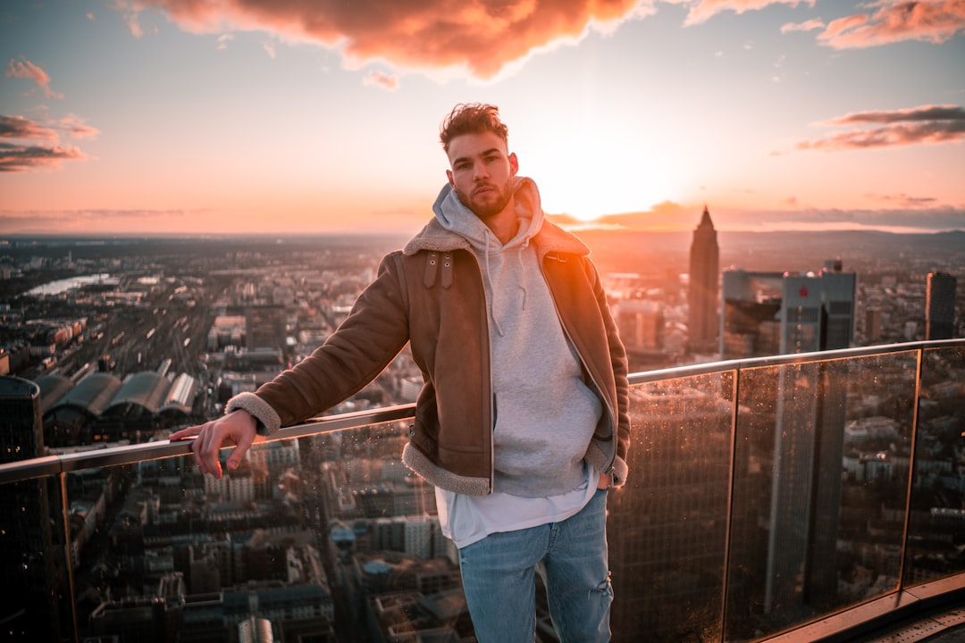 Confident man overlooking a city skyline, representing male strategy, self-improvement and modern manosphere themes
