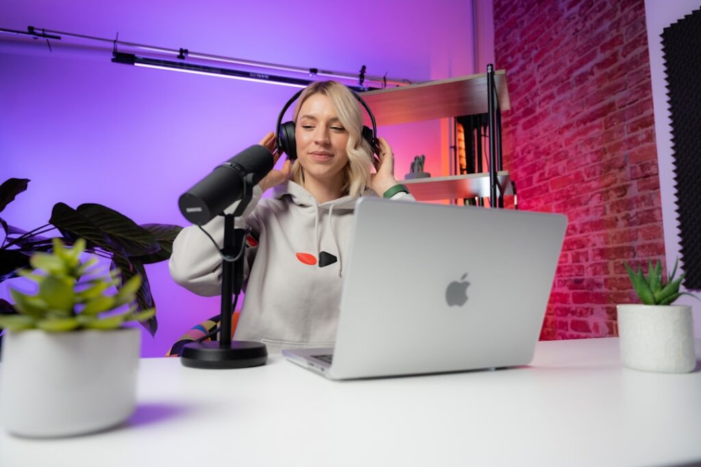 Content creator working in a professional video studio with camera and laptop