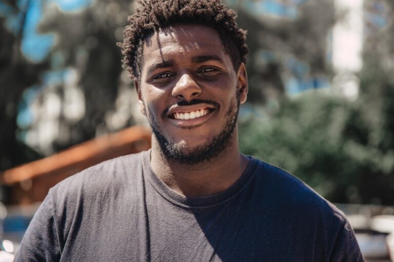 Black man smiling for an article about BlackPeopleMeet profile and messaging strategy