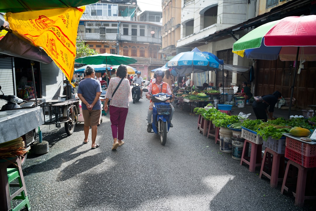 People walking through a bustling local market, illustrating cultural immersion while dating abroad