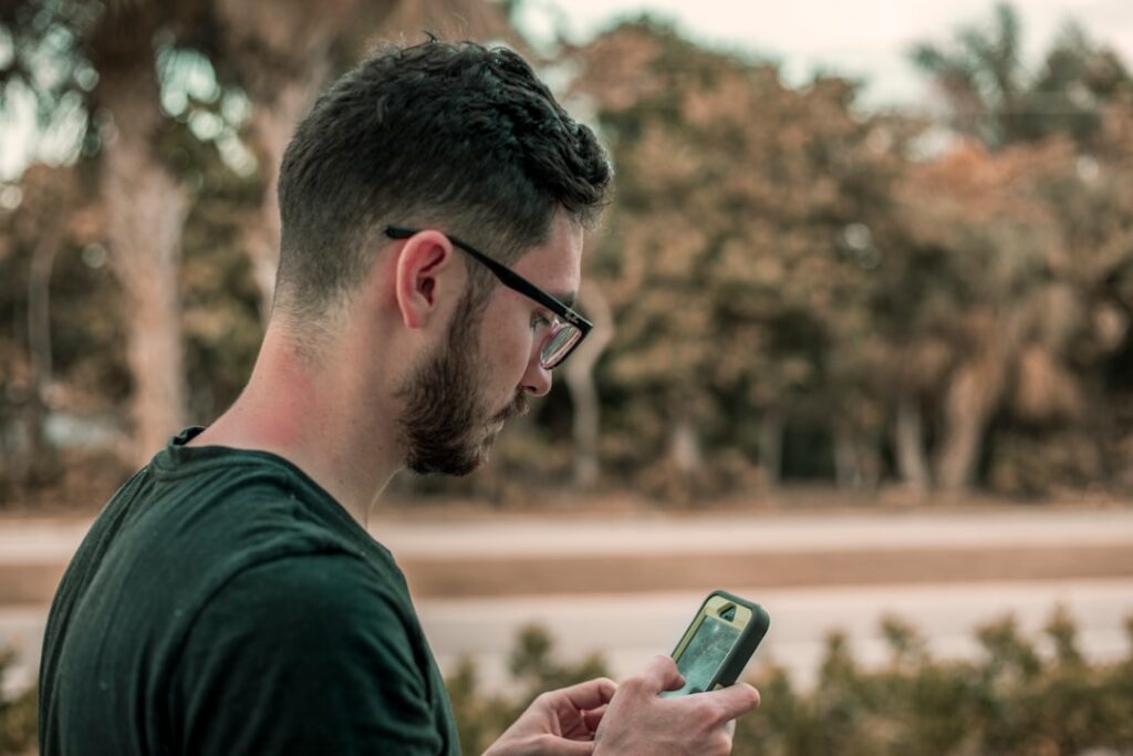 Man reviewing his dating profile photo order on a smartphone