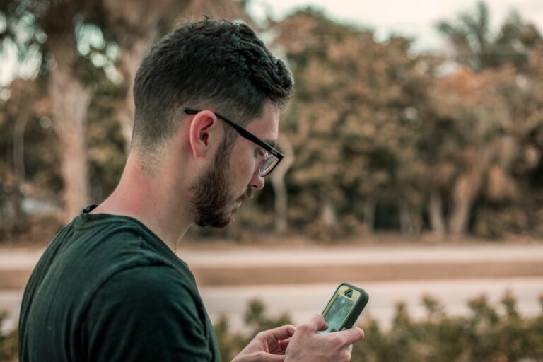 Man reviewing his dating profile photo order on a smartphone