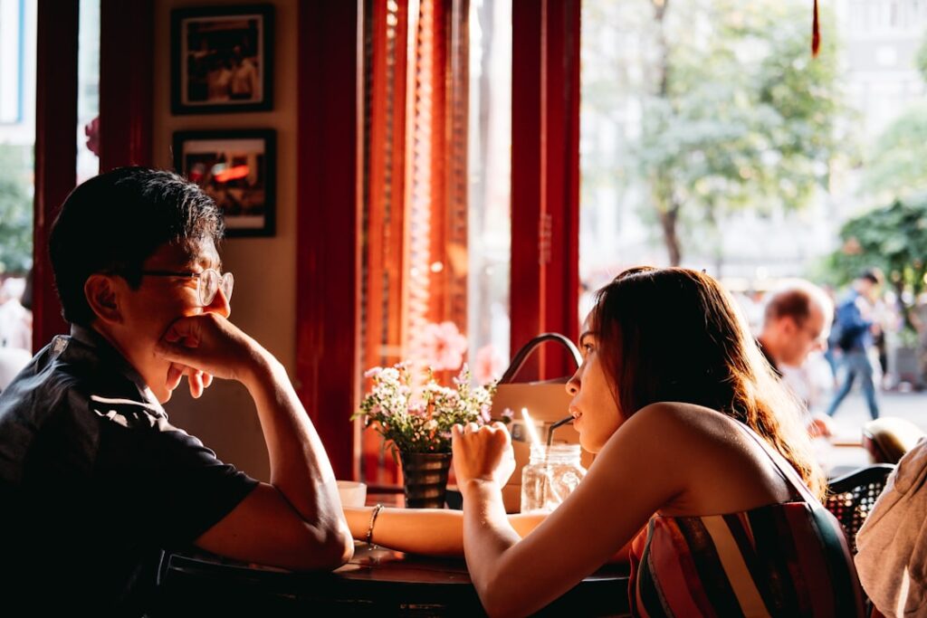 Couple smiling and talking together outdoors, illustrating relaxed first-date conversation