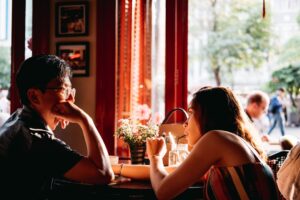 Couple smiling and talking together outdoors, illustrating relaxed first-date conversation