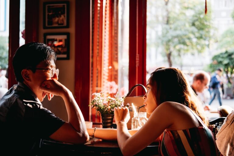 Couple smiling and talking together outdoors, illustrating relaxed first-date conversation