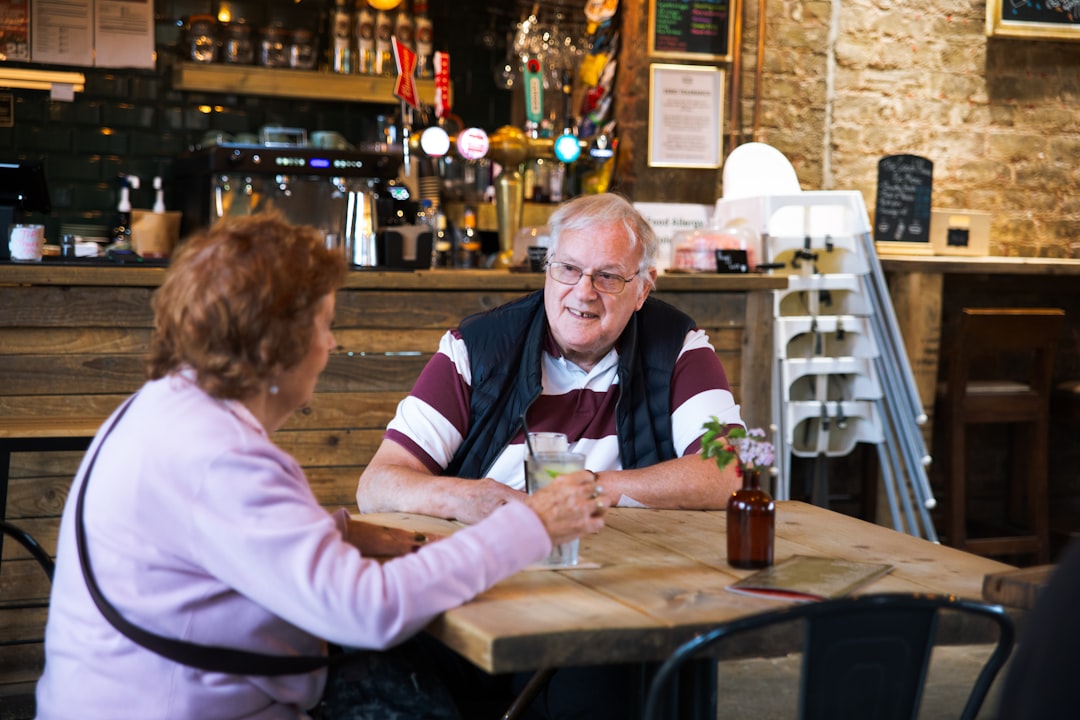 Couple talking across a table in a relaxed social setting, illustrating first-date chemistry and conversation