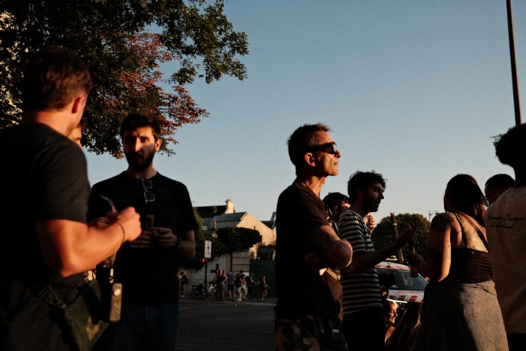Group of adult friends socializing outdoors, illustrating the importance of male friendship and a healthy social life