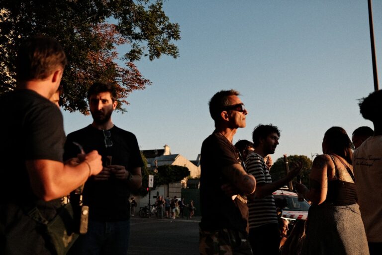 Group of adult friends socializing outdoors, illustrating the importance of male friendship and a healthy social life
