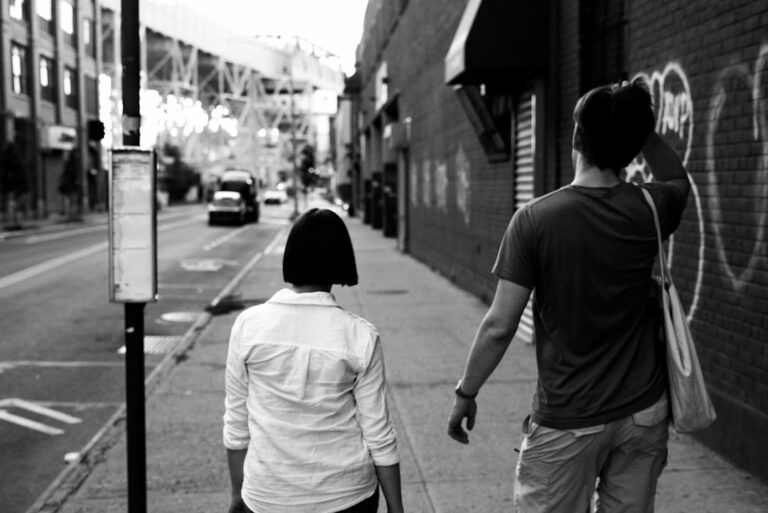 Man and woman having a respectful conversation on a city sidewalk