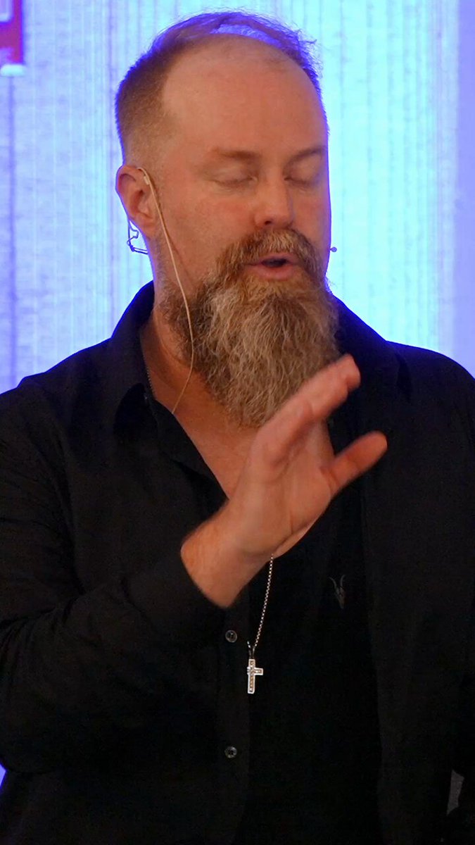 Owen Cook speaking at a personal-development event