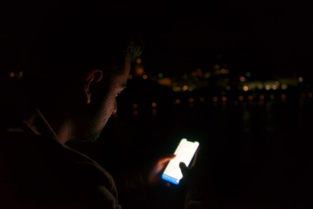 Man using a smartphone with a deliberate quality-first dating app strategy