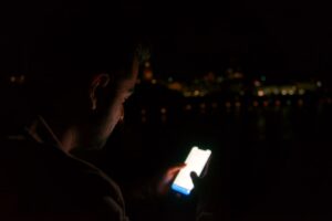 Man using a smartphone with a deliberate quality-first dating app strategy