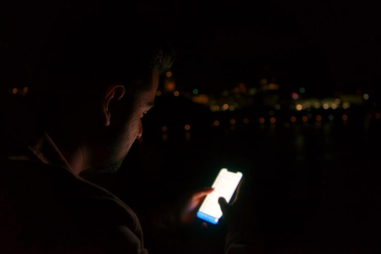 Man using a smartphone with a deliberate quality-first dating app strategy