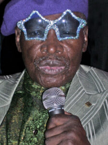 Rudy Ray Moore, creator and star of Dolemite, speaking into a microphone