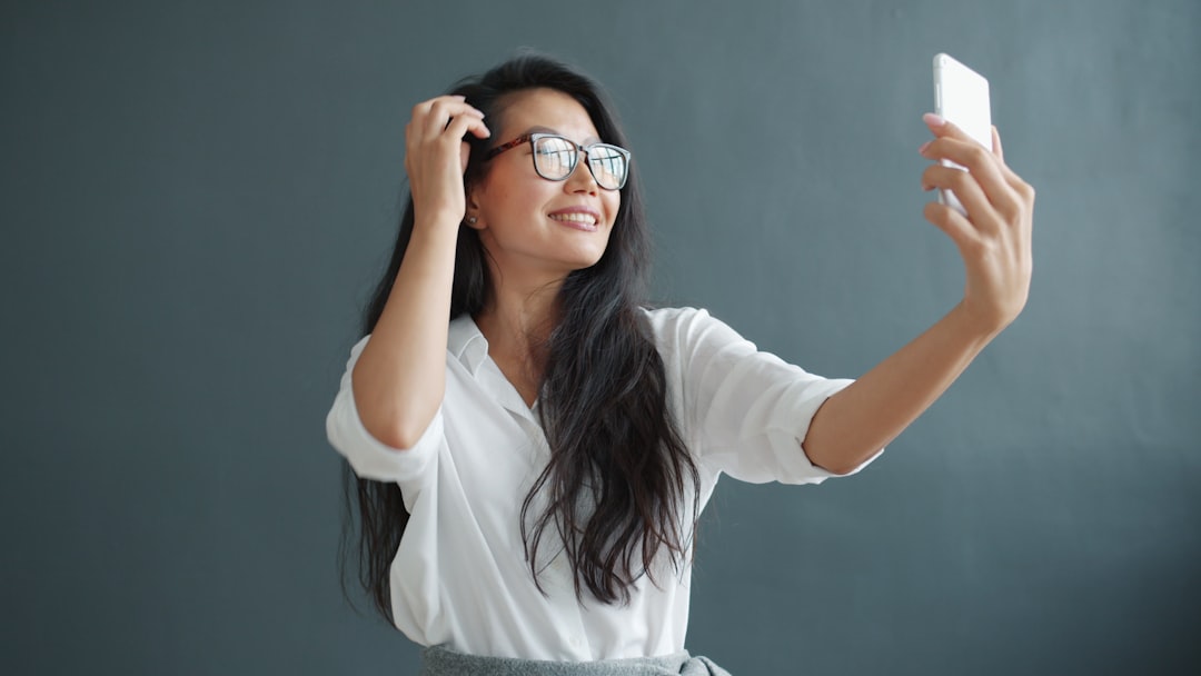 Woman creating social media content with a smartphone in a studio setting