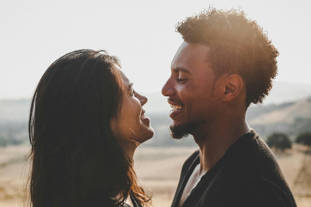 A Black couple facing each other during a conversation