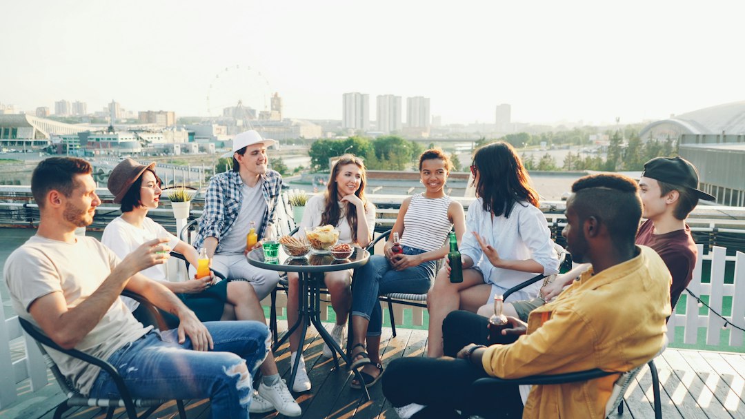 Friends talking at a rooftop social gathering