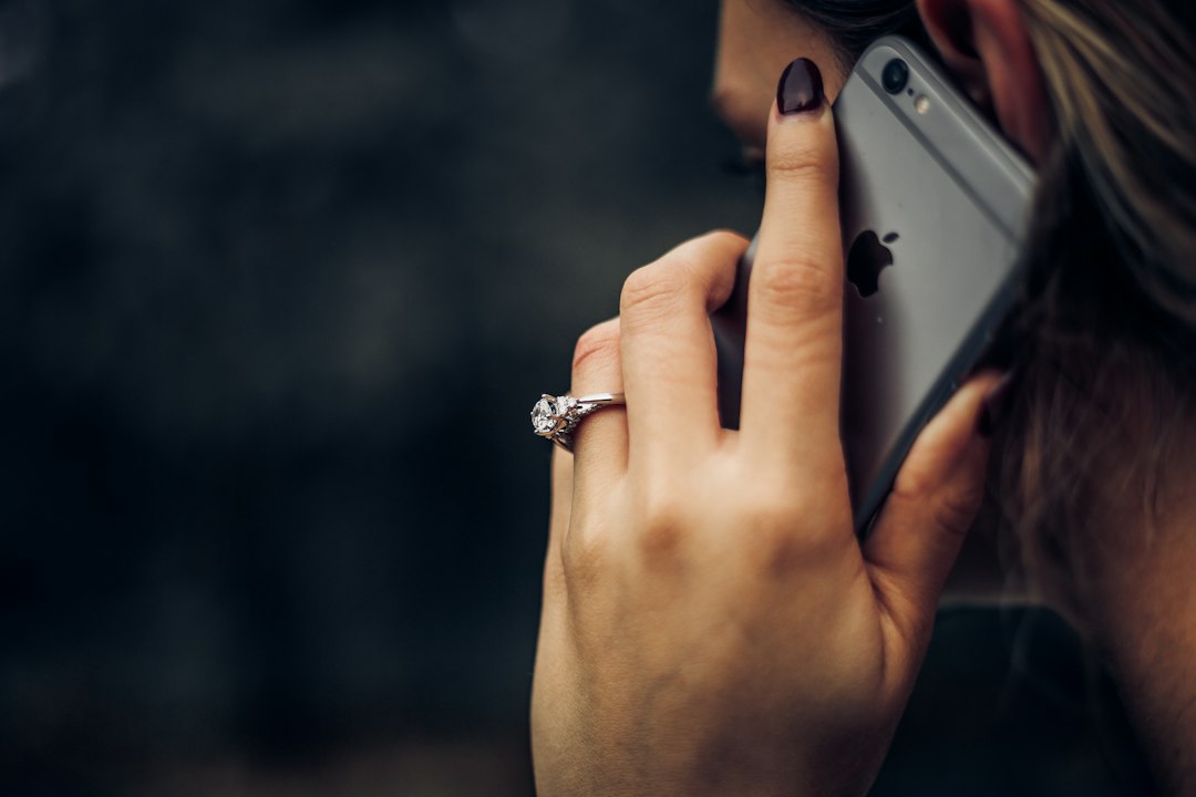 An engagement ring beside a smartphone