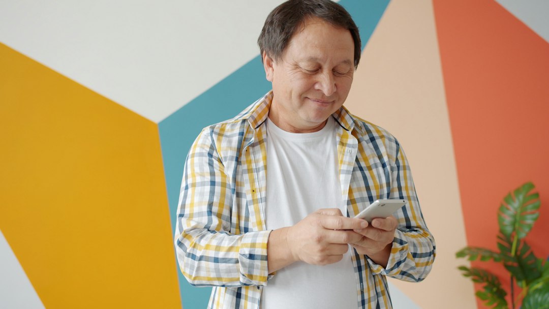 A mature man using a smartphone